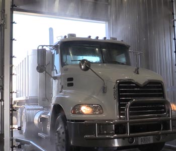 Biosecurity wash system for trucks that carry food washing a white truck
