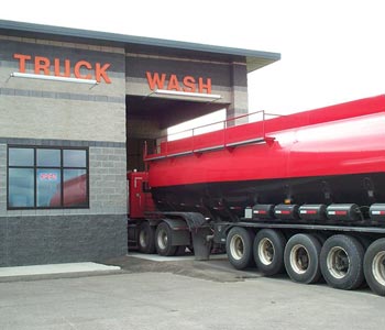 Red tanker truck going through the wash