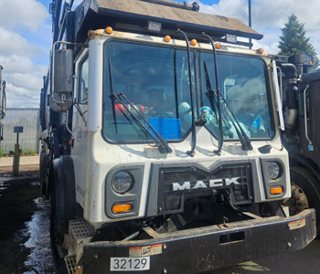 a garbage truck very dirty before cleaning with hydro-chem system's 2 step soaps